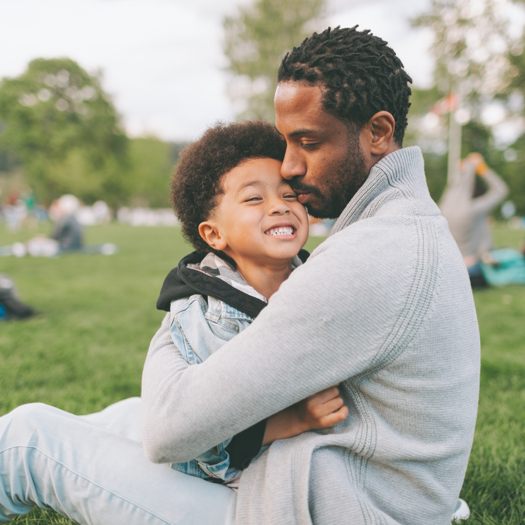 dad hugging smiling son