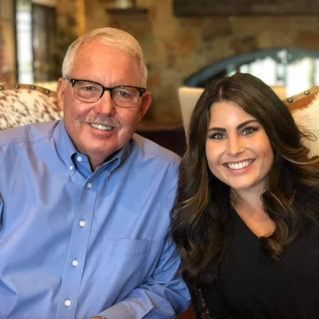 picture of Dr. John Trent and Kari Trent Stageberg sitting in chairs with brick in the background
