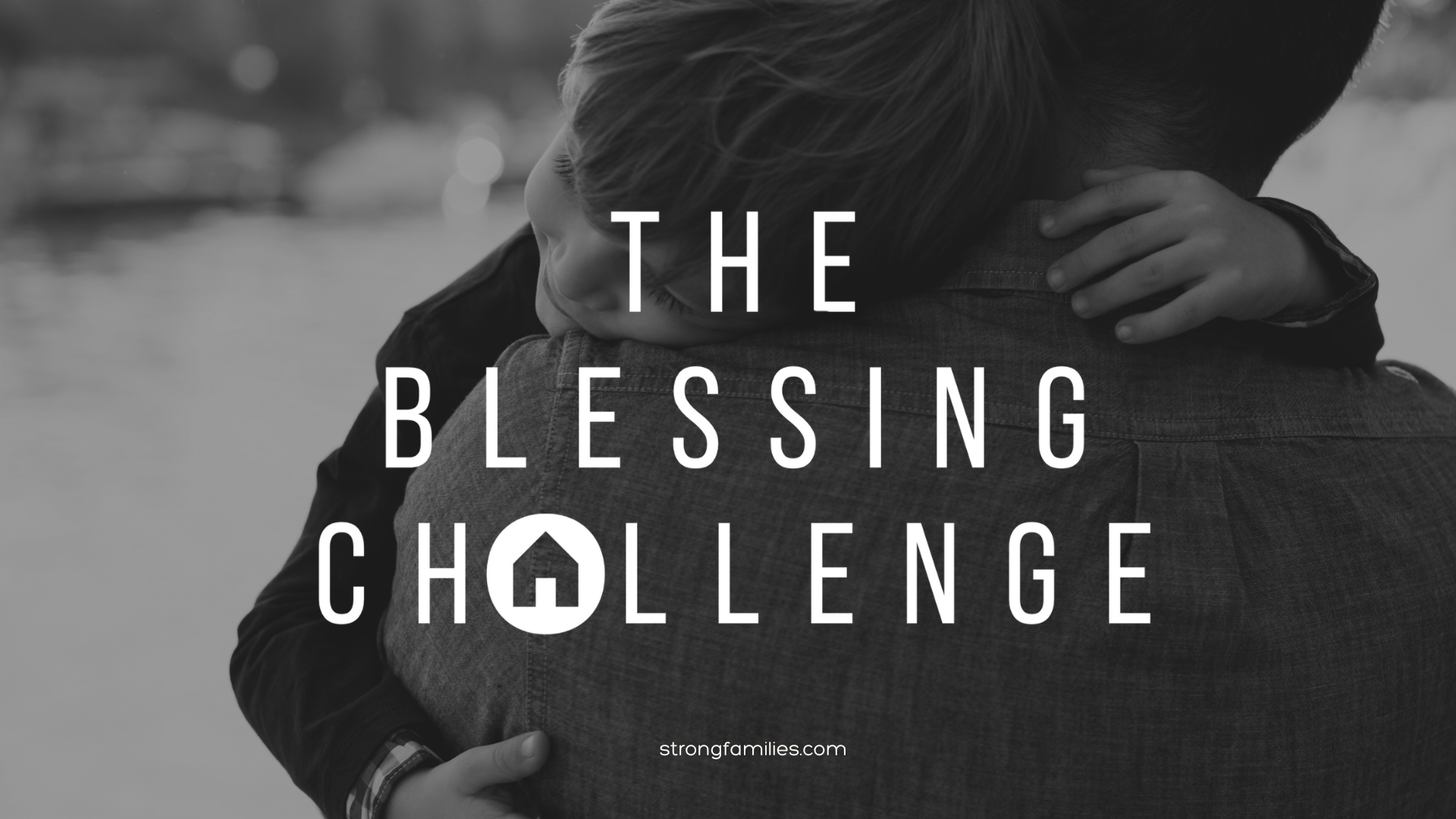 The Blessing Challenge logo in white over a picture of a dad holding his son in black and white